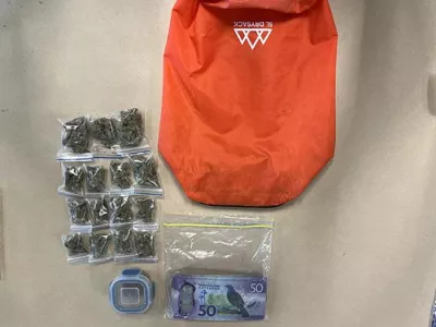 In this image provided by the New Zealand Police items donated to a charity story including marijuana and cash are displayed in Southland, New Zealand, Feb. 18, 2026. (New Zealand Police via AP)