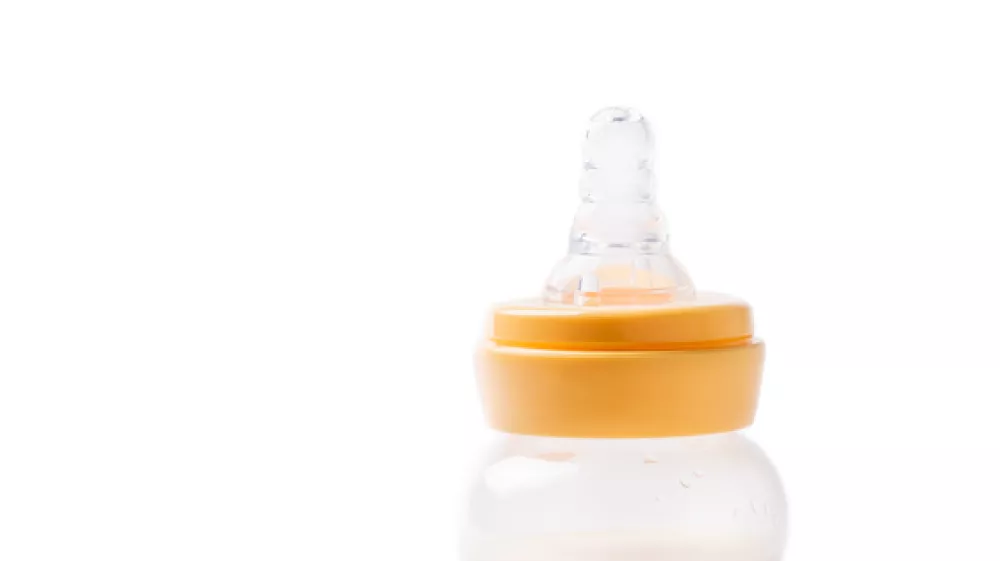 Milk bottle for baby feeding and dummy isolated on white background