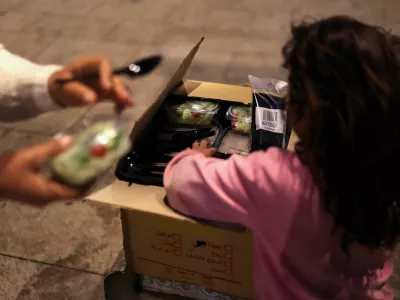 A girl gets food from a box, as her family was displaced following an escalation between Hezbollah and Israel amid the U.S.-Israeli conflict with Iran, in Beirut, Lebanon, March 10, 2026. REUTERS/Claudia Greco