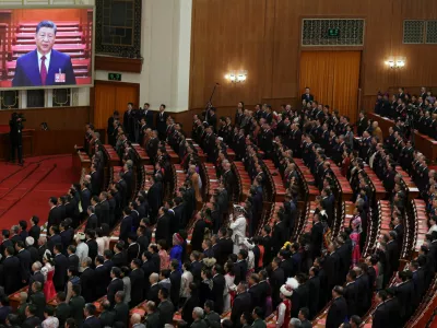 A screen shows Chinese President Xi Jinping as delegates sing the national anthem at the closing session of the National People's Congress (NPC) at the Great Hall of the People in Beijing, China March 12, 2026. REUTERS/Florence Lo