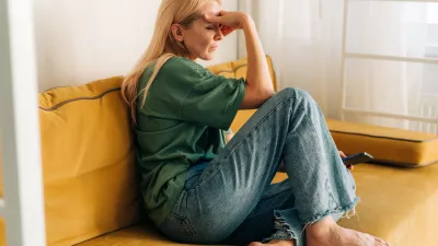 Depressed sad middle aged woman sitting on sofa at home. / Foto: Ilona Titova