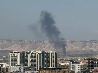 Smoke rises from the site of a drone crash on the outskirts of Erbil, Iraq, March 12, 2026. Picture taken on a mobile phone. REUTERS/Khalid Al-Mousily