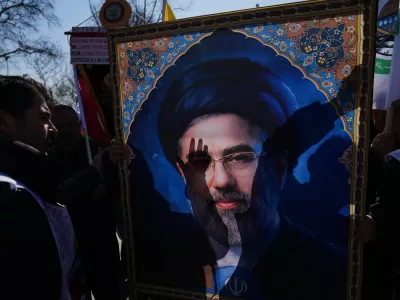 People hold a portrait of new Iranian Supreme Leader Ayatollah Mojtaba Khamenei as they march during a protest against Israel and the U.S., in Istanbul, Friday, March 13, 2026. (AP Photo/Francisco Seco)
