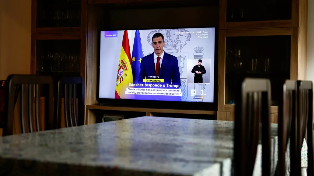 A TV screen shows a live broadcast of Spain's Prime Minister Pedro Sanchez, as he delivers an institutional statement to address the latest international developments, after U.S. President Donald Trump said on Tuesday that the U.S. would cut off all trade with Spain after the European country refused to let the U.S. military use its bases for missions linked to strikes on Iran, at a house in Ronda, Spain, March 4, 2026. REUTERS/Jon Nazca