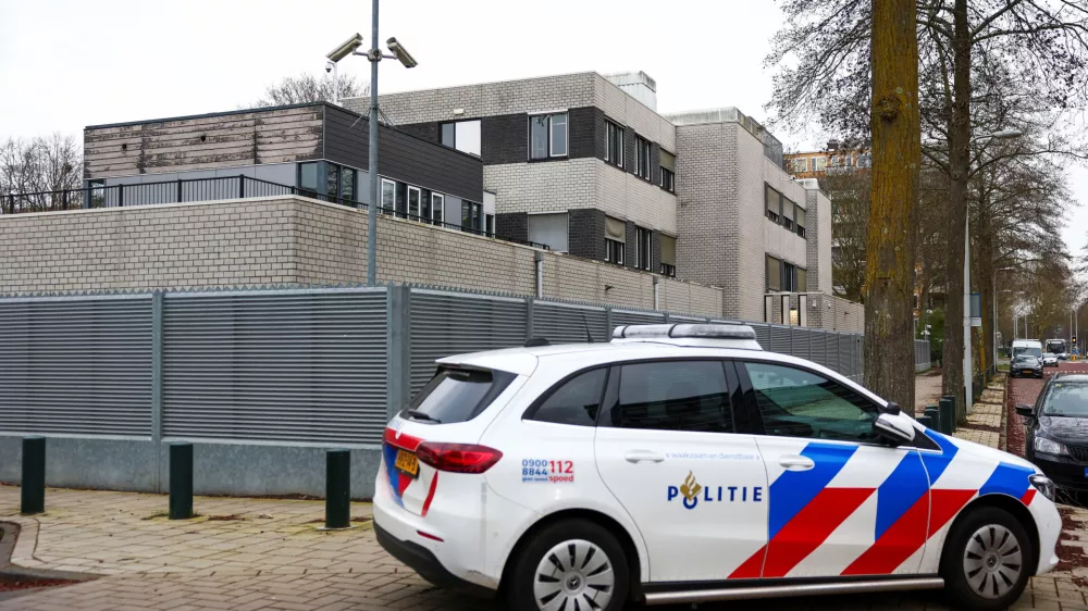 A police vehicle outside a Jewish school following an explosion that caused minor damages, in Amsterdam, Netherlands, March 14, 2026. REUTERS/Piroschka van de Wouw