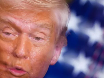 In this image taken with a slow shutter speed, President Donald Trump speaks during a women's history month event in the East Room of the White House, Thursday, March 12, 2026, in Washington. (AP Photo/Julia Demaree Nikhinson)