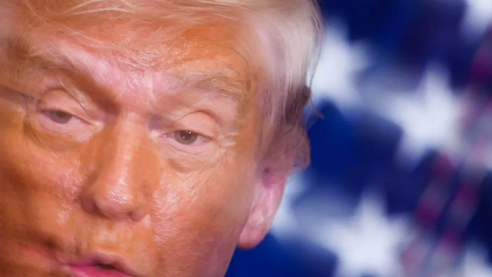 In this image taken with a slow shutter speed, President Donald Trump speaks during a women's history month event in the East Room of the White House, Thursday, March 12, 2026, in Washington. (AP Photo/Julia Demaree Nikhinson)