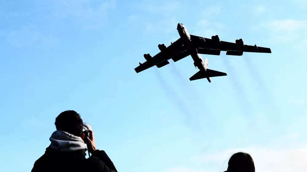 A plane spotter takes pictures as a U.S. Air Force Boeing B-52 Stratofortress takes off at RAF Fairford airbase, used by United States Air Force (USAF) personnel, amid the U.S.&ndash;Israeli conflict with Iran, in Fairford, Gloucestershire, Britain, March 15, 2026. REUTERS/Jack Taylo