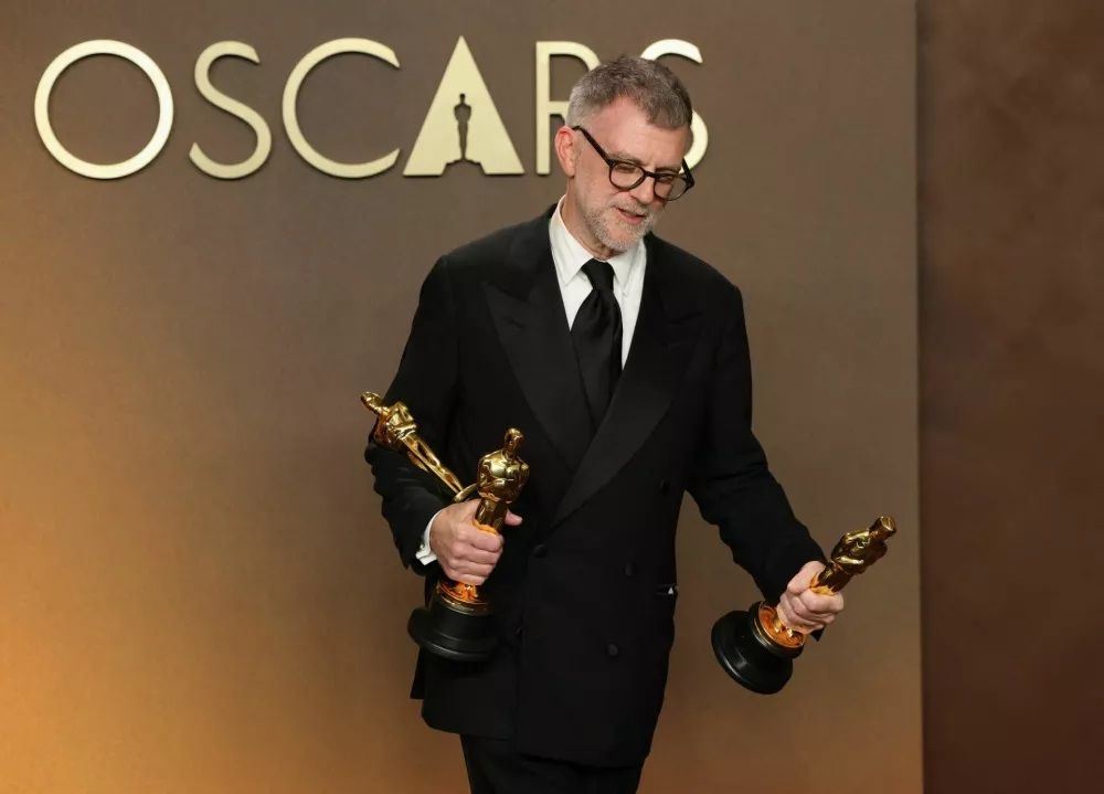 Paul Thomas Anderson holds the Oscars for Best Adapted Screenplay, Best Director, and Best Picture for "One Battle After Another", in the Oscars photo room at the 98th Academy Awards in Hollywood, Los Angeles, California, U.S., March 15, 2026. REUTERS/Mario Anzuoni
