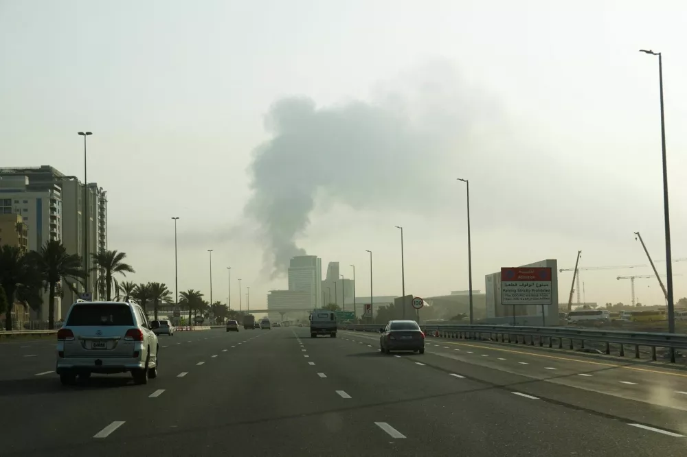 Smoke rising from the Dubai International Airport is seen through the windshield of a vehicle, after a drone attack hit a fuel tank, according to Dubai authorities, amid the U.S.-Israel conflict with Iran, in Dubai, United Arab Emirates, March 16, 2026, REUTERS/Stringer