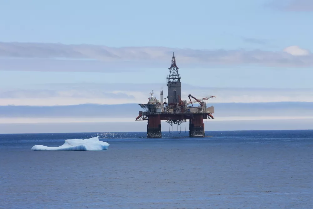 An Iceberg floating by an oil rig, Bay Bulls, Newfoundland and Labrador, Canada