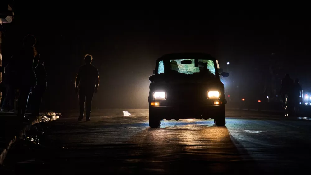 A vehicle drives down a street during a blackout in Havana, Wednesday, March 4, 2026. (AP Photo/Ramon Espinosa)