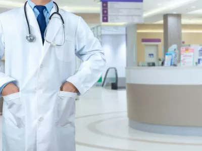 Smart doctor with a stethoscope around his neck on the hospital blurred background, Healthcare medical technology concept, copy space, Color effect tone, Copy space for text.,Image: 922087993, License: Royalty-free, Restrictions:, Model Release: yes