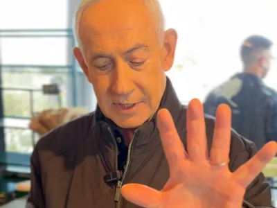Israeli Prime Minister Benjamin Netanyahu shows his hand as he speaks at a cafe, amid the U.S.-Israeli conflict with Iran, in Jerusalem, March 15, 2026, in this screen grab taken from a handout video. Benjamin Netanyahu via Telegram/Handout via REUTERS  THIS IMAGE HAS BEEN SUPPLIED BY A THIRD PARTY. NO RESALES. NO ARCHIVES. MANDATORY CREDIT. TEXT OVERLAY FROM SOURCE. VERIFICATION: - Cafe interiors matched file imagery of the area. - Date verified by multiple corroborating videos and photos posted by the cafe on March 15. - No older versions of the video were found posted online before March 15. - Coordinates: 31.775368725805468, 35.12722970081208