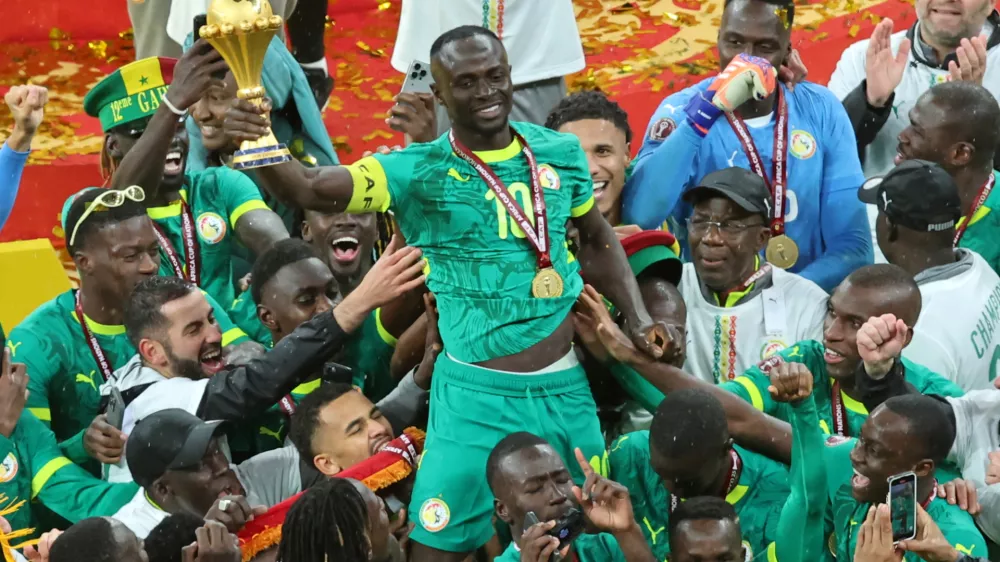 FILE - Senegal's Sadio Mane holds the trophy aloft as he celebrates with teammates after winning the Africa Cup of Nations final soccer match between Senegal and Morocco in Rabat, Morocco, Sunday, Jan. 18, 2026. (AP Photo/Youssef Loulidi, File)