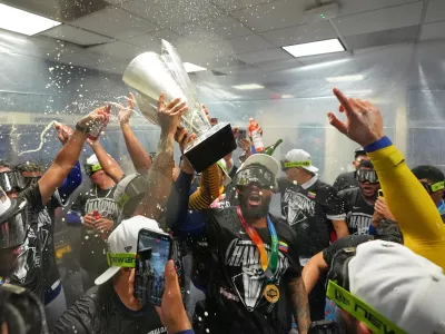 The Venezuela team celebrate with the trophy after defeating the United States in the championship game of the World Baseball Classic, Tuesday, March 17, 2026, in Miami. (AP Photo/Rebecca Blackwell)