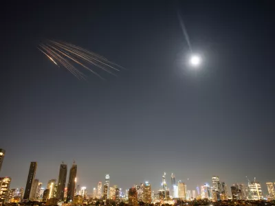 Missiles launched from Iran streak across the sky over central Israel, Thursday, March 5, 2026. (AP Photo/Ohad Zwigenberg)