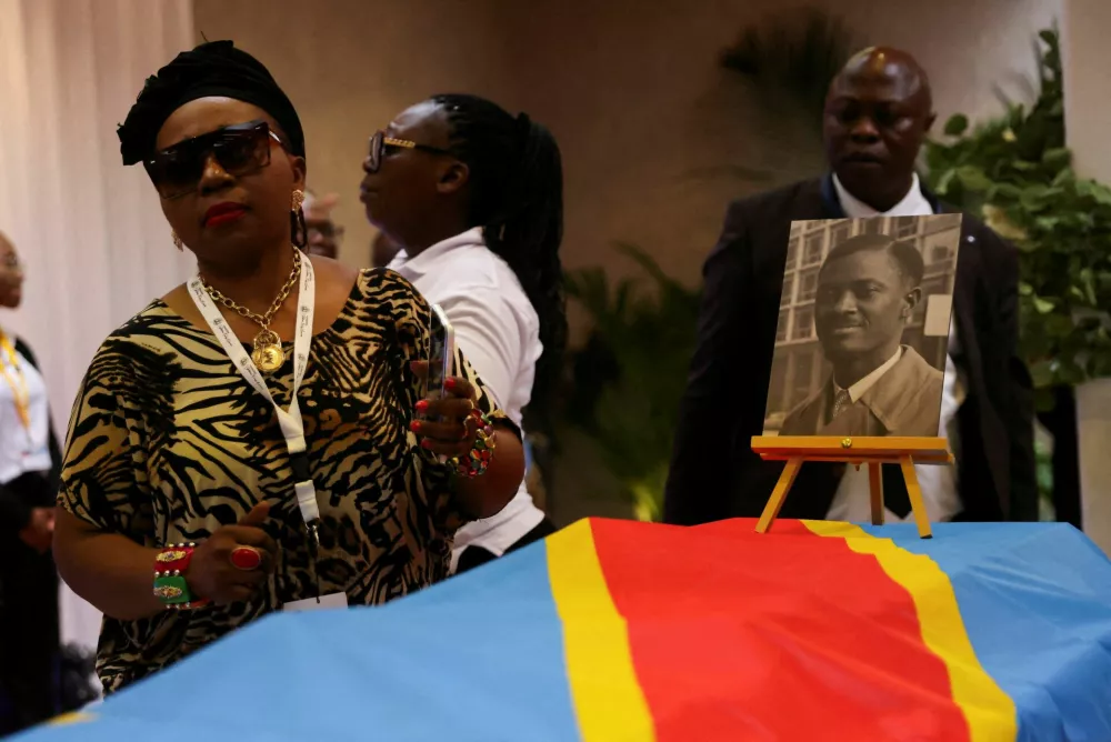 FILE PHOTO: People take part in a ceremony after the remains of the Democratic Republic of the Congo's first Prime Minister Patrice Emery Lumumba were symbolically handed over to the murdered leader's children and to an official delegation, in Brussels, Belgium June 21, 2022. REUTERS/Johanna Geron/File Photo