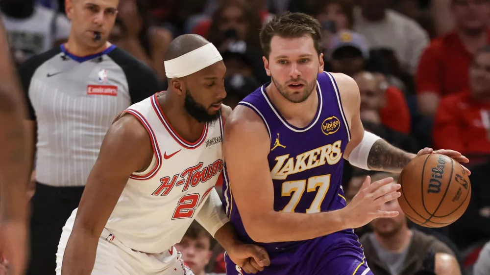 Mar 18, 2026; Houston, Texas, USA; Los Angeles Lakers guard Luka Doncic (77) leans on Houston Rockets guard Josh Okogie (20) in the second quarter at Toyota Center. Mandatory Credit: Thomas Shea-Imagn Images