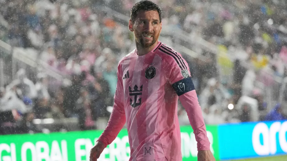 Inter Miami forward Lionel Messi (10) walks to kick a corner kick in heavy rain during the first half of a CONCACAF Champions Cup Round of 16 soccer match against Nashville, Wednesday, March 18, 2026, in Fort Lauderdale, Fla. (AP Photo/Marta Lavandier)