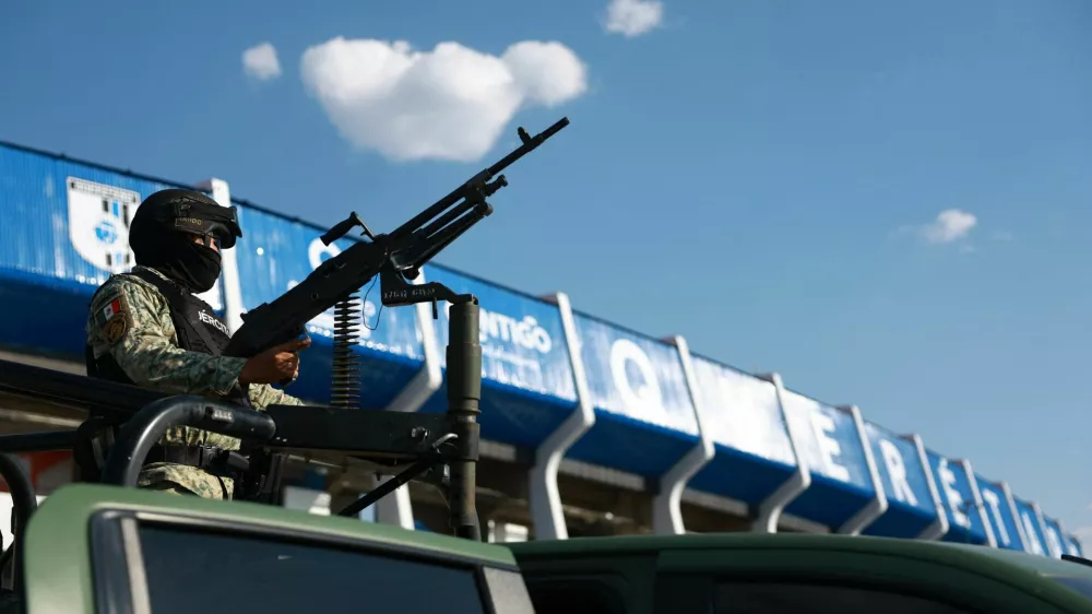 Soccer Football - International friendly - Mexico v Iceland - Estadio Corregidora, Santiago de Queretaro, Mexico - February 25, 2026 A member of the Mexican army with a gun outside the stadium before the match days after a wave of blockades and attacks by organized crime triggered by a Mexican military operation in which Jalisco New Generation Cartel leader Nemesio Oseguera, known as "El Mencho," was killed REUTERS/Raquel Cunha
