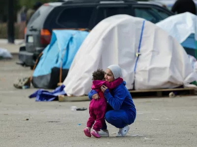 A woman hugs a child near shelters of displaced people on the day Muslim worshippers attend Eid al-Fitr prayers to mark the end of the holy fasting month of Ramadan, following an escalation between Hezbollah and Israel amid the U.S.-Israeli conflict with Iran, in Beirut, Lebanon, March 20, 2026. REUTERS/Yara Nardi