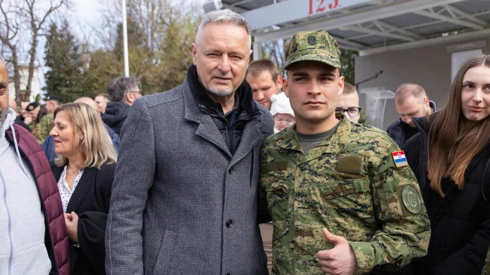Army cadet takes a picture with singer Marko Perkovic Thompson after the ceremonial oath in barracks of the 123rd Croatian Army Brigade in Pozega, March 20, 2026. REUTERS/Antonio Bronic