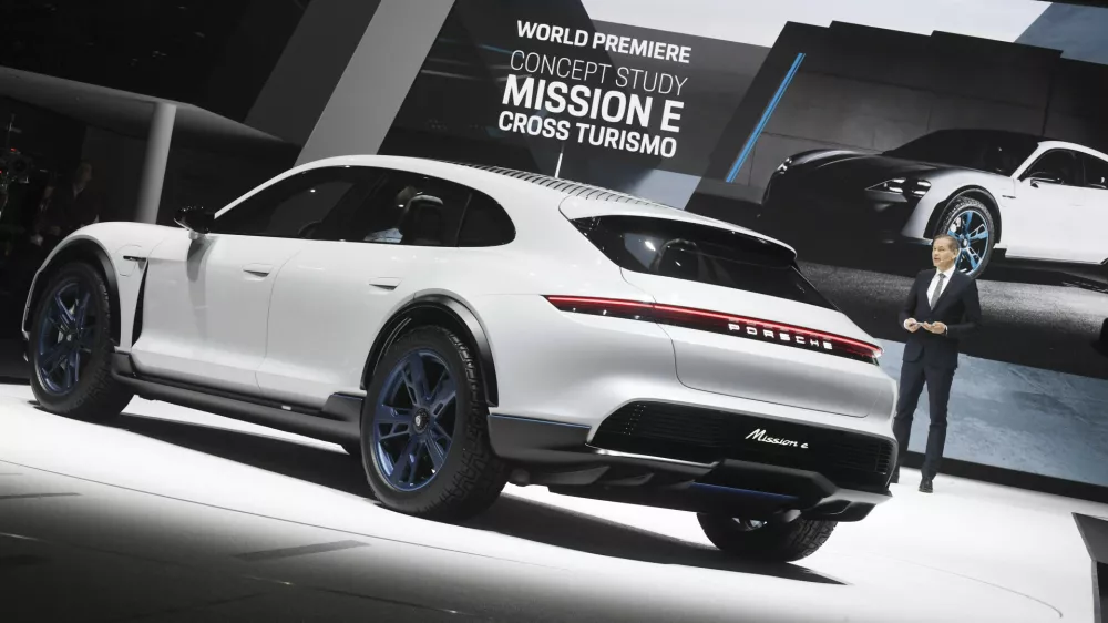 Oliver Blume, chairman of the board of Porsche, presenting Porsche's Mission E Cross Turismo during the first press day of the Geneva Motor Show in Geneva, Switzerland, 06 March 2018. This model is Porsche's presentation of a concept study for an electrical Cross Utility Vehicle (CUV). The 88th Geneva Motor Show starts on 08 March and ends on 18 March. About 180 exhibitors will be displaying 900 models and the organisers expect 700,000 visitors. Photo by: Uli Deck/picture-alliance/dpa/AP Images