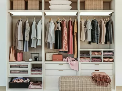 modern wooden wardrobe with women clothes hanging on rail in walk in closet design interior, 3d rendering