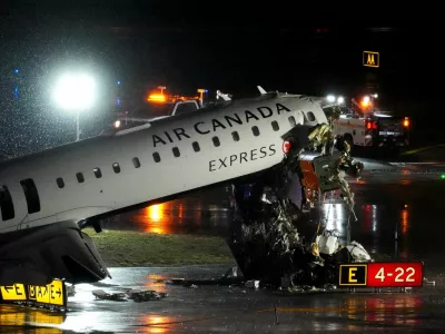 Debris hangs from a damaged Air Canada Express jet that had collided with a fire truck at New York's LaGuardia Airport in Queens, New York, U.S., March 23, 2026. REUTERS/Adam Gray   TPX IMAGES OF THE DAY
