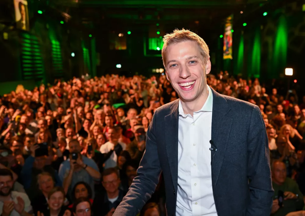 Dominik Krause, right, top candidate of the Green party, on stage at the Green Party election party after the run-off election for the office of Lord Mayor in the Bavarian capital of Munich, Germany, Sunday, March 22, 2026. (Sven Hoppe/dpa via AP)