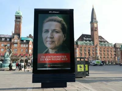People walk near an election advertisement for Mette Frederiksen, Denmark's Prime Minister and leader of the Social Democrats party ahead of parliamentary elections in Copenhagen, Denmark, March 23, 2026. REUTERS/Leonhard Foeger