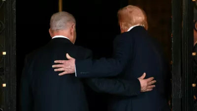 FILE PHOTO: U.S. President Donald Trump and Israeli Prime Minister Benjamin Netanyahu embrace as they walk into Trump's Mar-a-Lago club in Palm Beach, Florida, U.S., December 29, 2025. REUTERS/Jonathan Ernst/File Photo