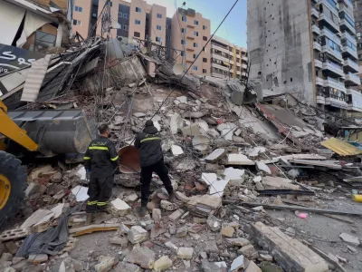 Civil defense workers check a destroyed building that was hit by an Israeli airstrike in Dahiyeh, Beirut's southern suburbs, Lebanon, Tuesday, March 24, 2026. (AP Photo/Hussein Malla)