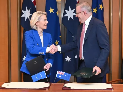 European Commission President Ursula von der Leyen, left, and Australian Prime Minister Anthony Albanese shake hands after signing a joint statement during a ceremony at Parliament House in Canberra, Tuesday, March 24, 2026. (Lukas Coch/AAP Image via AP)