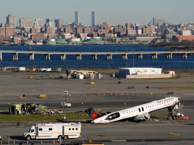 An Air Canada Express jet and Port Authority fire truck lay on the side of a runway at LaGuardia Airport, Tuesday, March 24, 2026, after colliding with each other shortly after the jet landed in New York Sunday night. (AP Photo/Yuki Iwamura)
