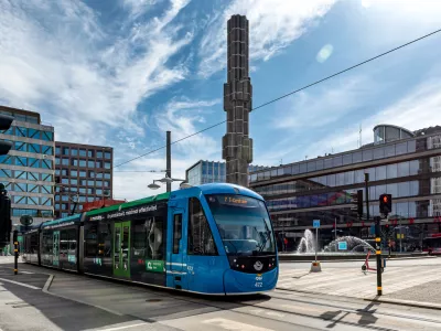 Stockholm, Sweden - May 06, 2024: Tram passing in front of the glass sculpture called Kristallvertikalaccent on Sergel Square with Kulturhuset in the background