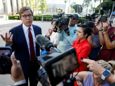 Lawyer Mark Lanier, of the plaintiff Kaley G.M., speaks with members of the media outside court in a key test case accusing Meta and Google's YouTube of harming children's mental health through addictive social media platforms in Los Angeles, California, U.S., March 24, 2026. REUTERS/Caroline Brehman