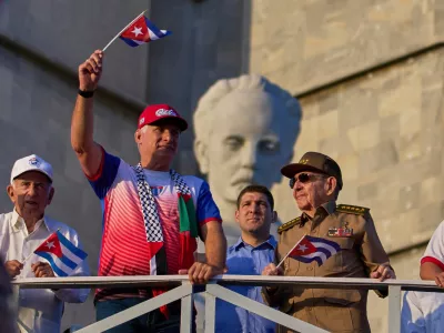 FILE - Cuba's President Miguel Diaz-Canel holds up a Cuban flag as he watches the May Day parade next to Raul Castro, second from right, and Raul Castro's grandson, Raul Guillermo Rodriguez Castro, at Revolution Square in Havana, May 1, 2025. (AP Photo/Ramon Espinosa, File)