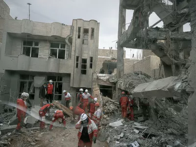 FILE - First responders inspect the remains of a residential building hit in an overnight strike during the U.S.-Israeli military campaign in Tabriz, Iran, March 24, 2026. (AP Photo/Matin Hashemi, File)