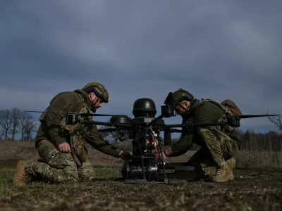 Service members of the 422nd Unmanned Systems Regiment attach a small air bomb to a heavy strike drone before a test flight at a training ground, amid Russia's attack on Ukraine, in Zaporizhzhia region, Ukraine March 23, 2026. REUTERS/Stringer