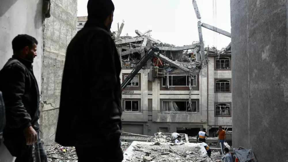 A man looks at a residential building damaged by a strike, amid the U.S.-Israeli conflict with Iran, in Tehran, Iran, March 27, 2026. Majid Asgaripour/WANA (West Asia News Agency) via REUTERS ATTENTION EDITORS - THIS PICTURE WAS PROVIDED BY A THIRD PARTY   TPX IMAGES OF THE DAY