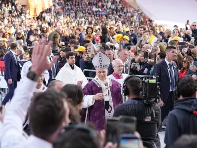 Pope Leo XIV leaves at the end of a mass at Stade Louis II in Fontvieille, Monaco, Saturday, March 28, 2026. (AP Photo/Laurent Cipriani)