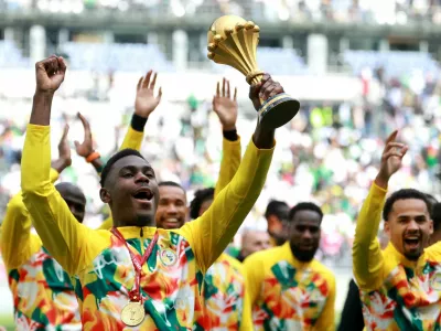 Soccer Football - International Friendly - Senegal v Peru - Stade de France, Saint-Denis, France - March 28, 2026 Senegal's Moussa Niakhate celebrates with the CAF Africa Cup of Nations trophy before the match REUTERS/Stephanie Lecocq   TPX IMAGES OF THE DAY