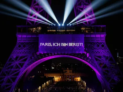 The Eiffel Tower lights up to mark the announcement of concert dates and ticket sales for singer Celine Dion's upcoming ten concerts in September and October in Paris, France, March 30, 2026. REUTERS/Benoit Tessier