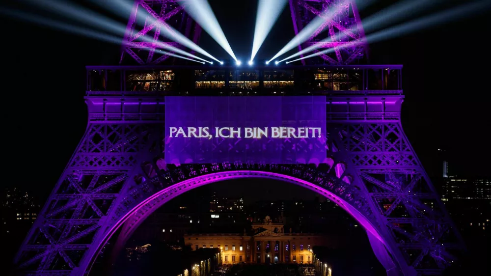 The Eiffel Tower lights up to mark the announcement of concert dates and ticket sales for singer Celine Dion's upcoming ten concerts in September and October in Paris, France, March 30, 2026. REUTERS/Benoit Tessier