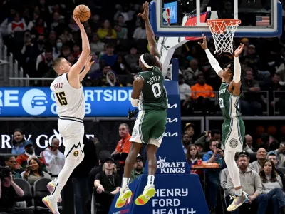 Mar 16, 2023; Detroit, Michigan, USA; Denver Nuggets center Nikola Jokic (15) shoots the ball over Detroit Pistons center Jalen Duren (0) and Detroit Pistons guard Jaden Ivey (23) in the fourth quarter at Little Caesars Arena. Mandatory Credit: Lon Horwedel-USA TODAY Sports