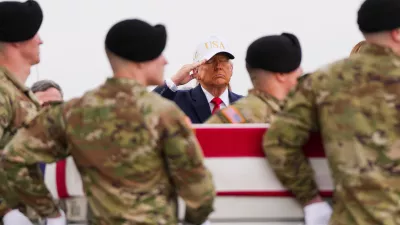 FILE - President Donald Trump salutes as an Army carry team moves a flag-draped transfer case with the remains of Sgt. Declan Coady, 20, of West Des Moines, Iowa, who was killed in a drone strike at a command center in Kuwait after the U.S. and Israel launched their military campaign against Iran, during a casualty return, March 7, 2026, at Dover Air Force Base, Del. (AP Photo/Julia Demaree Nikhinson, File)