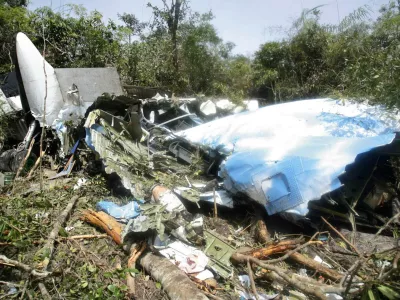 A Cambodian search and rescue official inspects the wreckage of an 44-seat Antonov AN-24 plane on June 27, 2007, which crashed into a jungle-clad mountain150 km (90 miles) southwest of Phnom Penh. Searchers found the wreckage of the plane carrying 22 people, including 13 Koreans and three Czechs, high on the Cambodian mountain on Wednesday but there were no survivors. REUTERS/Stringer (CAMBODIA)
