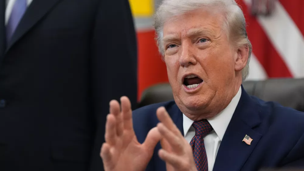 President Donald Trump answers questions from reporters after signing an executive order in the Oval Office of the White House Tuesday, March 31, 2026, in Washington. (AP Photo/Alex Brandon)